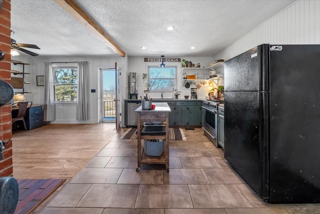 kitchen featuring open shelves, freestanding refrigerator, high end stove, a textured ceiling, and dark countertops