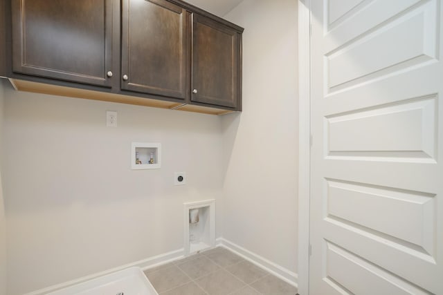 laundry area featuring light tile patterned flooring, hookup for an electric dryer, washer hookup, baseboards, and cabinet space