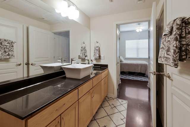 bathroom with connected bathroom, visible vents, a sink, and double vanity