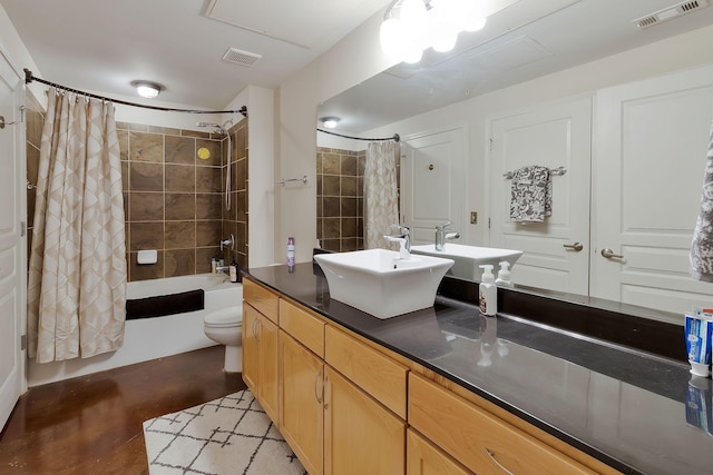 bathroom with visible vents, shower / bathtub combination with curtain, toilet, and vanity