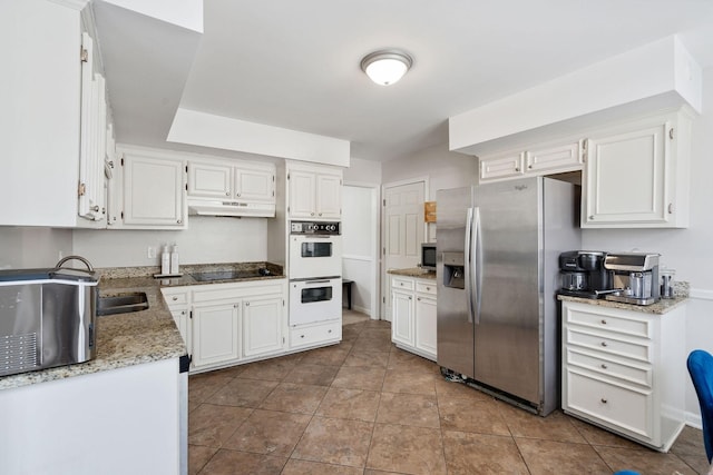 kitchen with light stone counters, tile patterned flooring, stainless steel appliances, under cabinet range hood, and white cabinetry