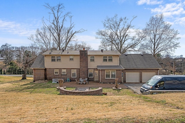 rear view of house with a garage, driveway, a lawn, a patio, and brick siding