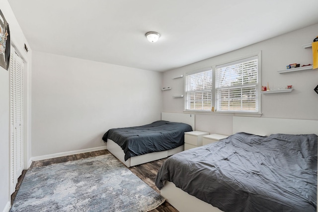 bedroom featuring wood finished floors and baseboards