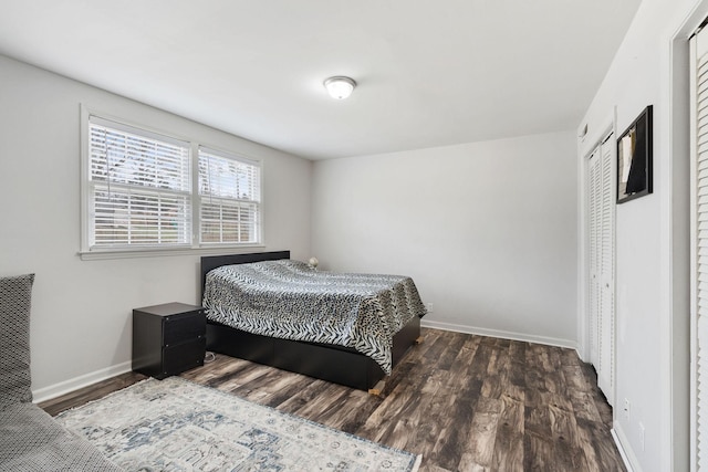 bedroom featuring a closet, baseboards, and wood finished floors