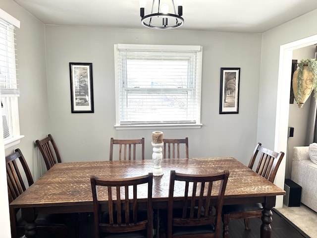 dining space featuring a wealth of natural light and a notable chandelier