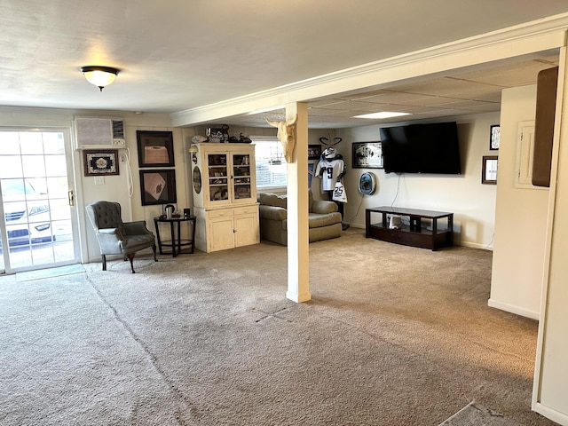 living room featuring a wealth of natural light, baseboards, and carpet flooring