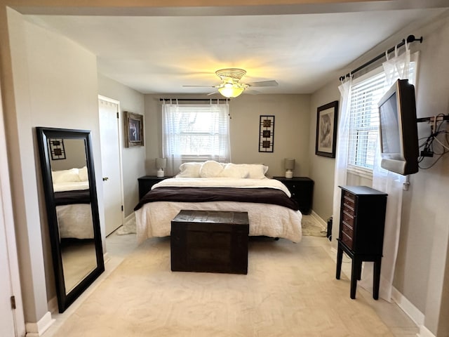 bedroom with baseboards and a ceiling fan