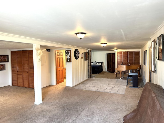 interior space featuring ornamental molding and carpet flooring