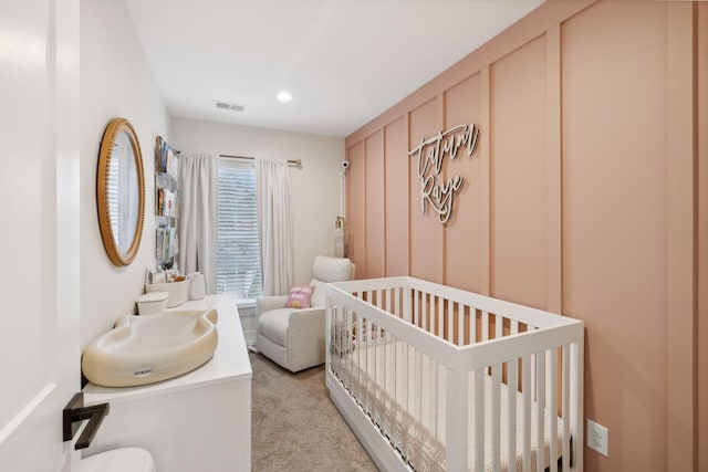 bedroom with recessed lighting, light carpet, a sink, visible vents, and a nursery area