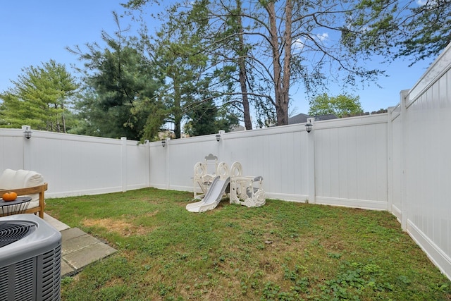 view of yard featuring a fenced backyard and central air condition unit