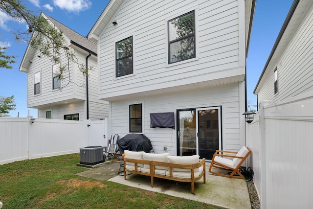 back of house featuring a patio, a fenced backyard, an outdoor hangout area, a lawn, and a gate