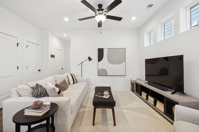 carpeted living room featuring baseboards, ceiling fan, visible vents, and recessed lighting