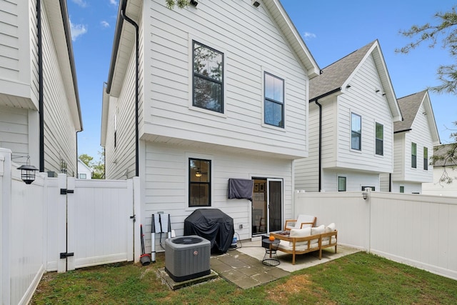 rear view of house featuring central AC, a yard, a patio area, and a fenced backyard