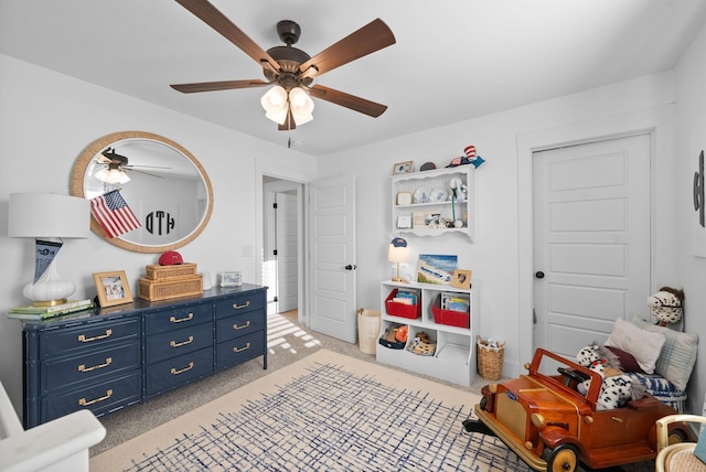 interior space featuring light colored carpet and ceiling fan