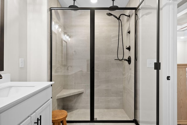 bathroom with a stall shower and vanity