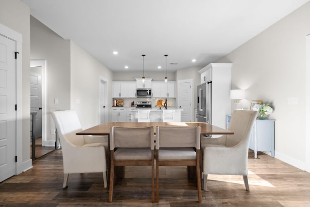 dining area featuring baseboards, dark wood-style flooring, and recessed lighting