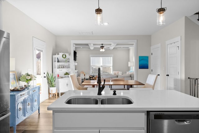 kitchen with a sink, visible vents, light countertops, and stainless steel dishwasher