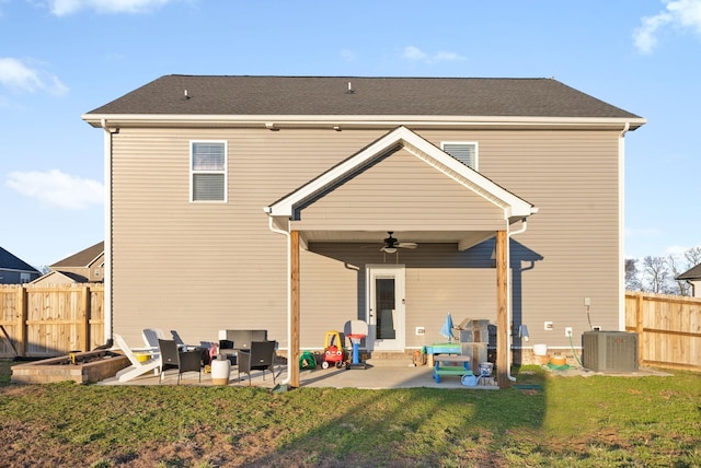 rear view of property featuring a ceiling fan, a patio, a lawn, and fence