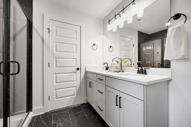 bathroom with marble finish floor, double vanity, a stall shower, and a sink