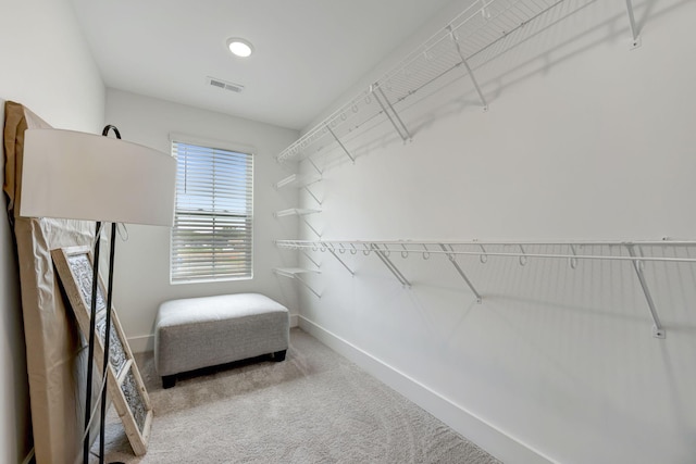 walk in closet featuring carpet flooring and visible vents