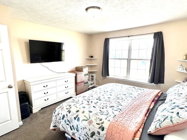 bedroom with a textured ceiling and carpet flooring