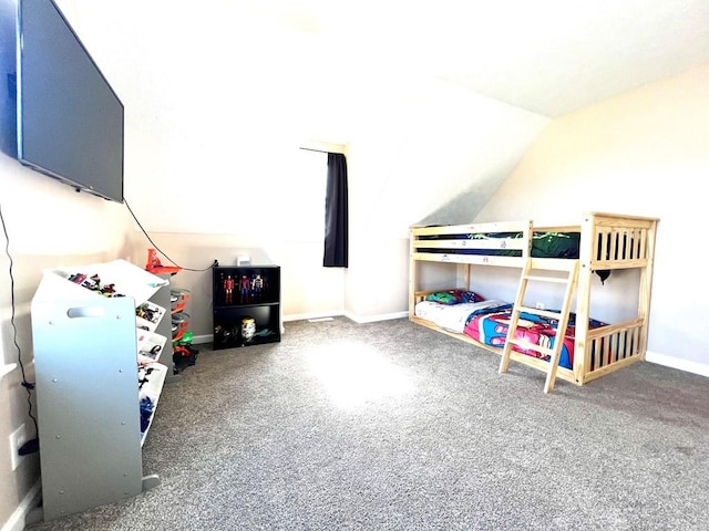 carpeted bedroom featuring baseboards and vaulted ceiling