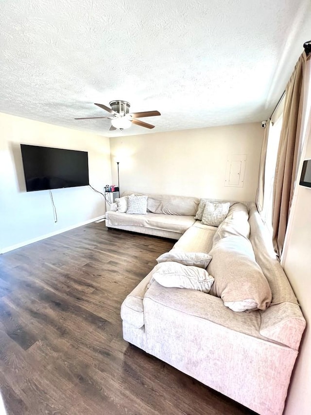 living area featuring a textured ceiling, ceiling fan, and wood finished floors