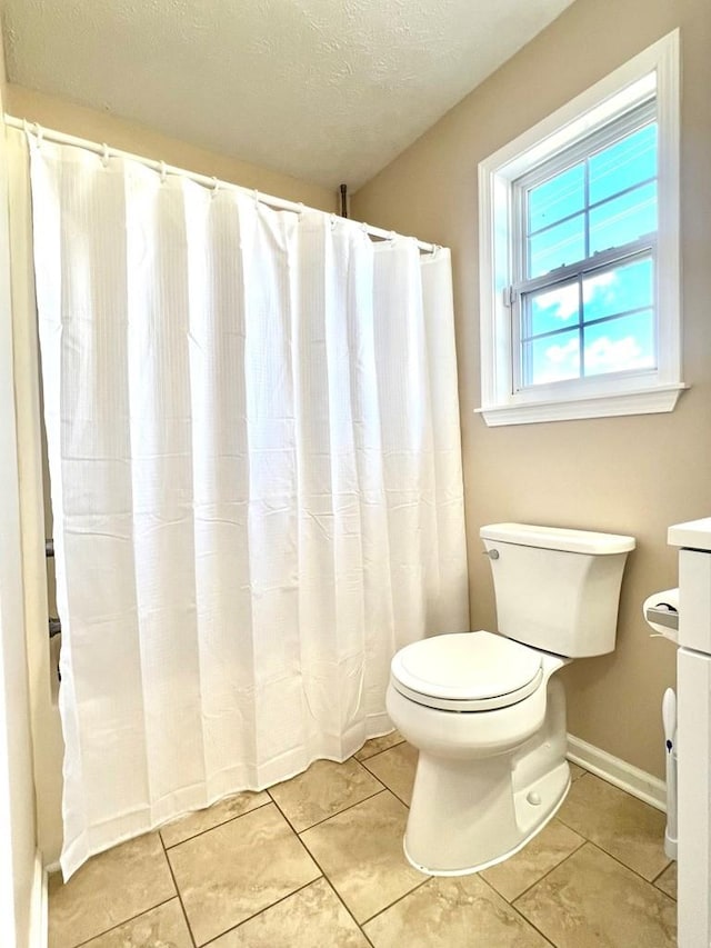 full bathroom with a shower with curtain, a textured ceiling, toilet, and tile patterned floors