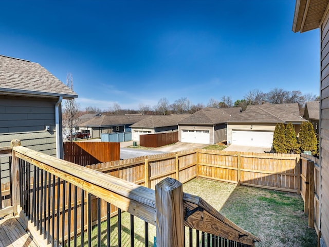 wooden deck with a residential view and a fenced backyard