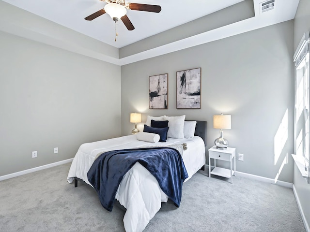 bedroom featuring carpet floors, baseboards, visible vents, and a ceiling fan