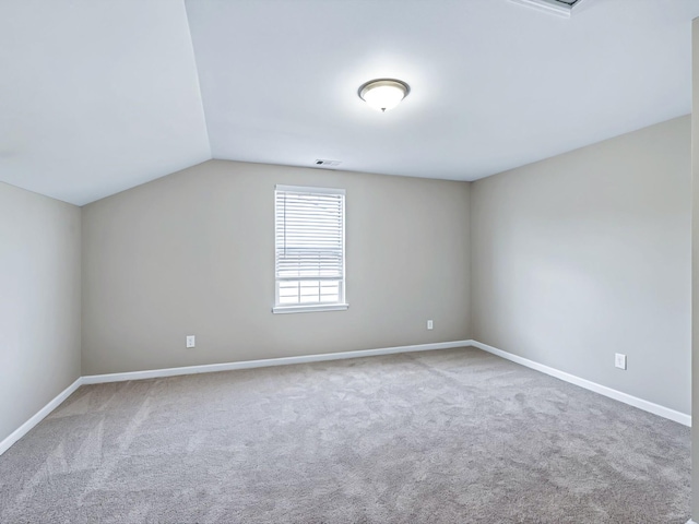 bonus room featuring lofted ceiling, baseboards, visible vents, and carpet flooring