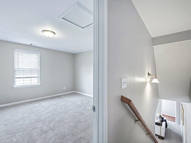interior space with visible vents, carpet flooring, attic access, and baseboards