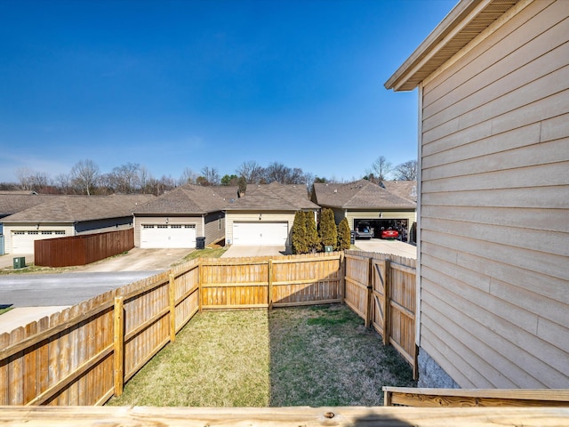 view of patio featuring a garage, fence private yard, and driveway