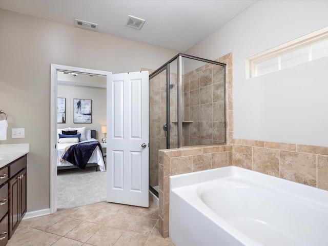 bathroom featuring visible vents, a garden tub, a shower stall, and ensuite bathroom
