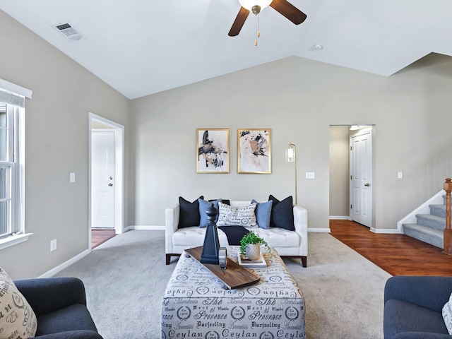living area with vaulted ceiling, stairway, carpet flooring, and visible vents