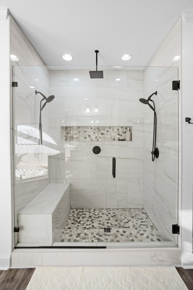 bathroom featuring a shower stall and wood finished floors