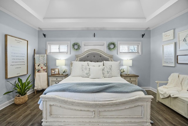 bedroom featuring dark wood-style floors, a raised ceiling, ornamental molding, and baseboards