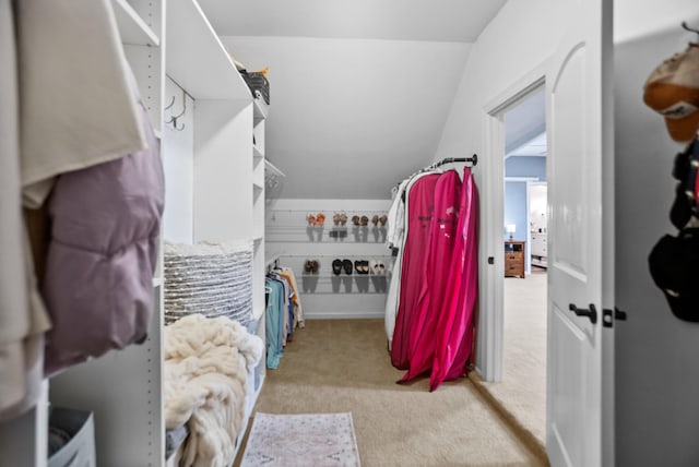 spacious closet with carpet and vaulted ceiling