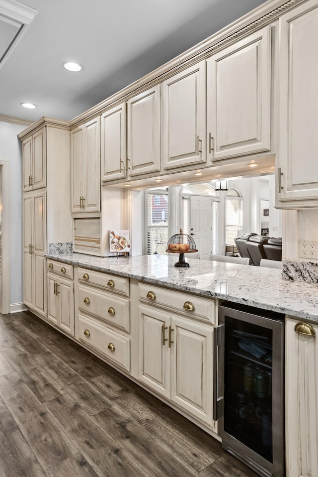 kitchen with dark wood-style floors, wine cooler, light stone counters, recessed lighting, and cream cabinets