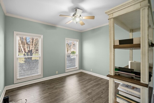 unfurnished bedroom with a ceiling fan, crown molding, baseboards, and wood finished floors