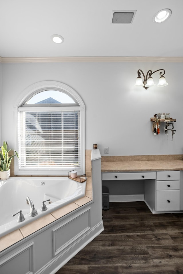 bathroom featuring recessed lighting, crown molding, a tub with jets, and wood finished floors