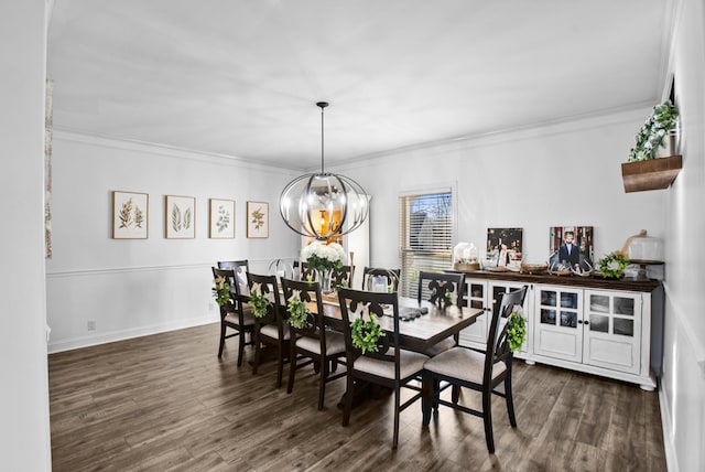 dining area with a chandelier, ornamental molding, dark wood-style flooring, and baseboards