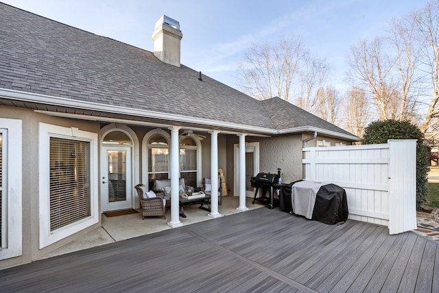 deck with a grill, an outdoor hangout area, fence, and ceiling fan