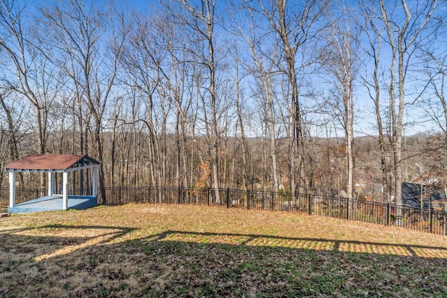 view of yard with fence and a view of trees