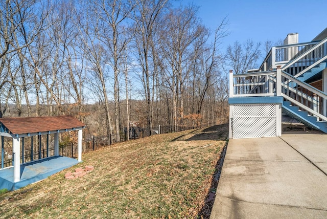 view of yard with stairs and fence