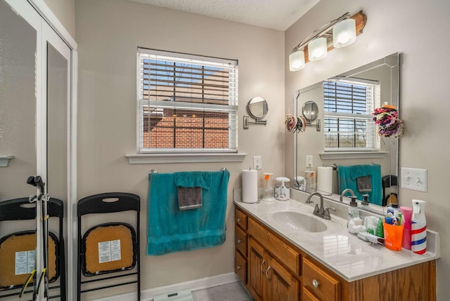 bathroom with a textured ceiling and vanity