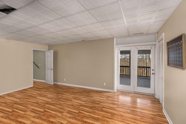 empty room featuring light wood-style flooring and baseboards