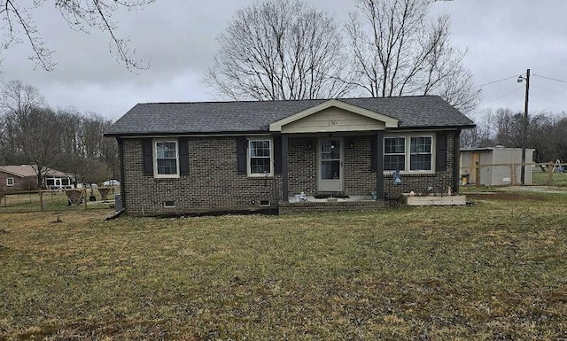 view of front facade featuring brick siding, crawl space, a shingled roof, and a front lawn