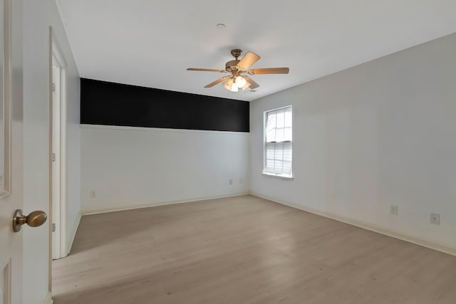 empty room with ceiling fan, baseboards, and light wood-style floors