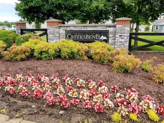 community sign featuring fence